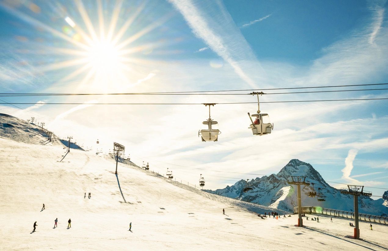 A ski lift is shown on the side of a mountain.