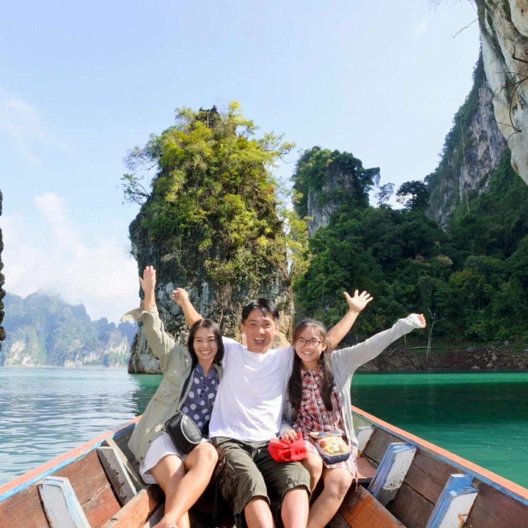 Three people on a boat in the water.